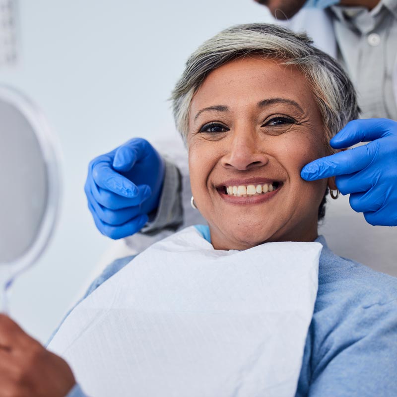 Happy senior woman at dentist for dental care, appointment or checkup