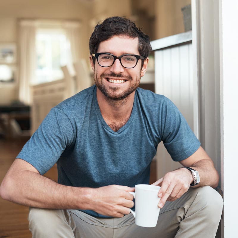 Cropped portrait of a handsome young man enjoying a cup of coffee in the morning